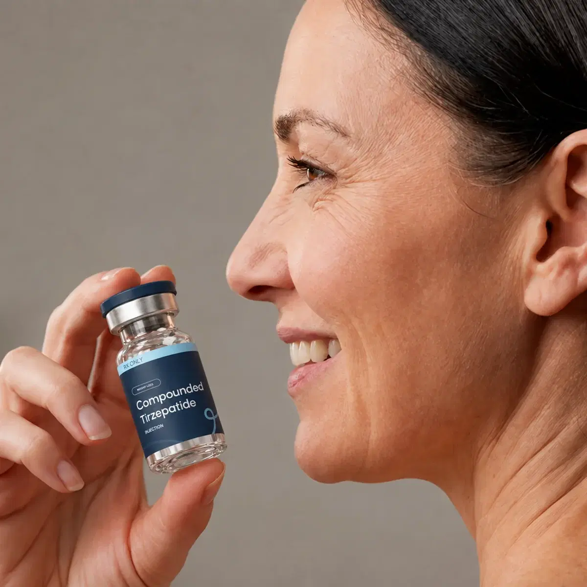 Woman looking at a LumiMeds Tirzepatide vial
