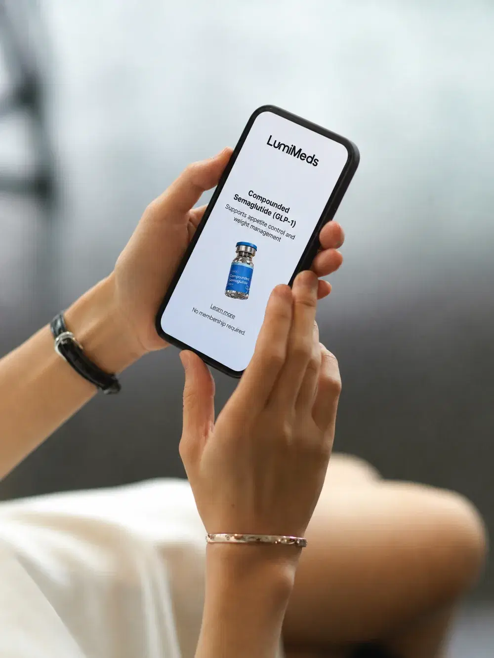 Hands holding a phone showing a compounded semaglutide treatment plan